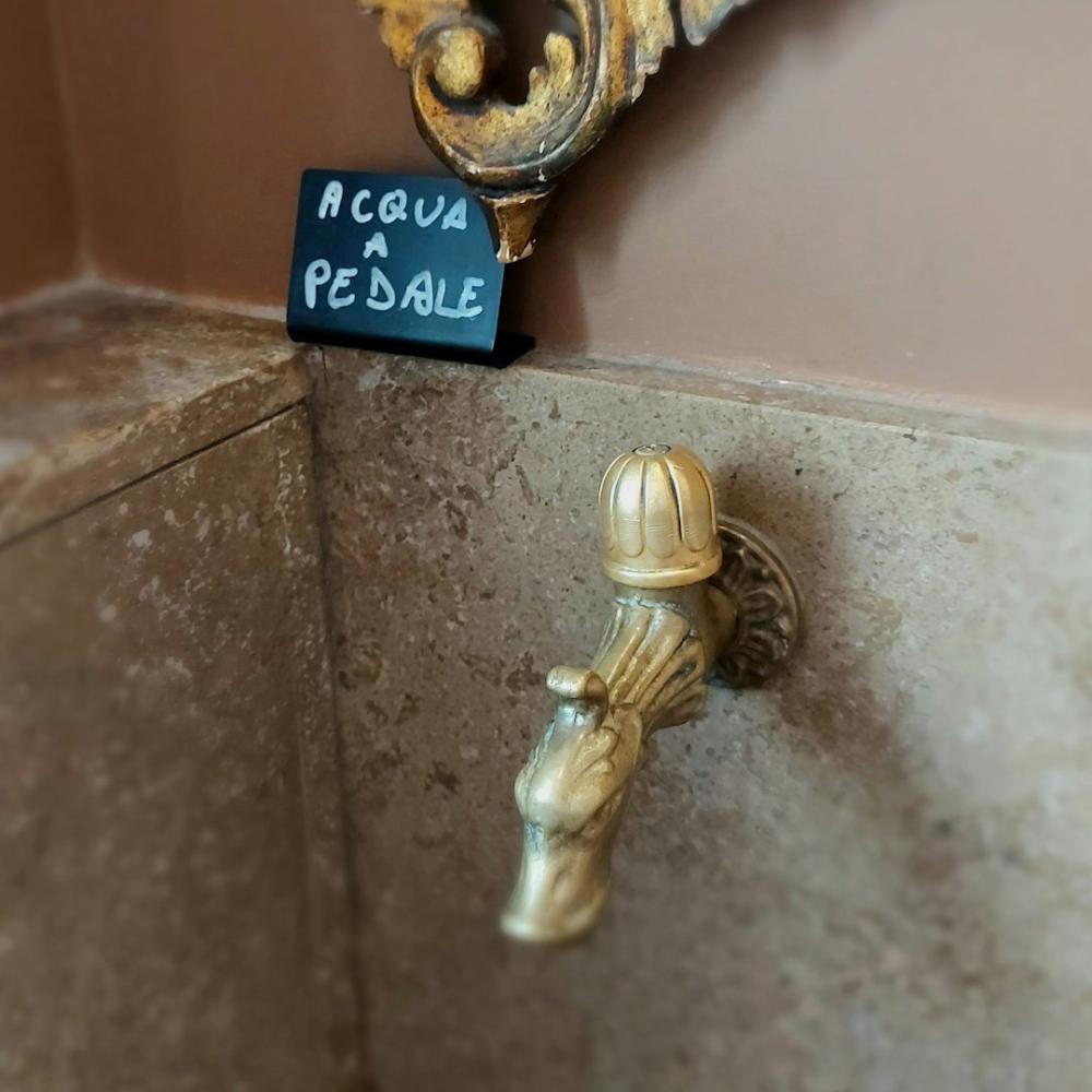Brushed brass radiator in a bathroom corner